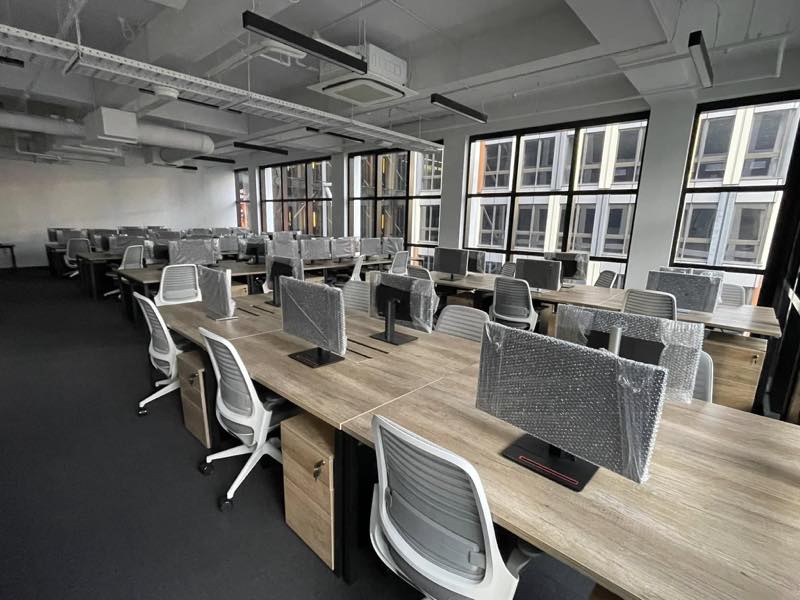 Office relocation with desks set up and monitors wrapped for transport